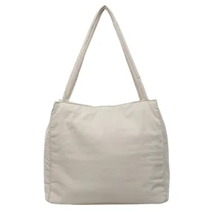 Minimalist beige large capacity canvas tote bag with wide shoulder straps for daily commute