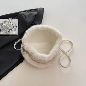White faux fur bucket bag with leather strap and soft plush texture for winter fashion