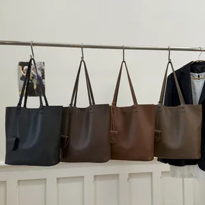 Minimalist lychee grain leather bucket bags in four colors with matching charms