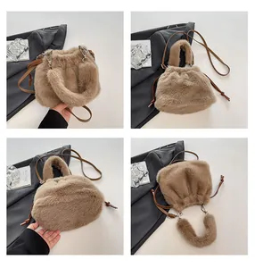 Detail of a brown faux fur bucket bag with drawstring closure and slim leather strap