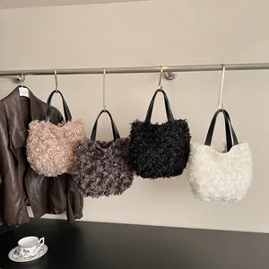 Fashionable plush bucket handbag with spiral curly faux fur and black leather handles