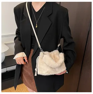 Detailed macro of beige plush faux fur bucket bag with drawstring and leather strap