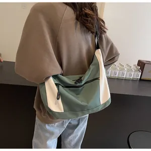 Detail showing the green and white contrast design of the nylon large capacity crossbody bag