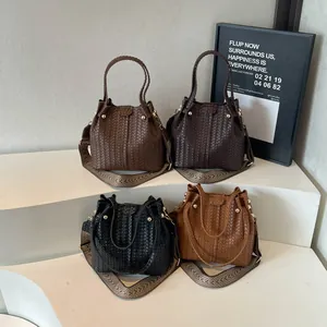 Woven bucket bags with jacquard shoulder straps shown in four colors on a white stage