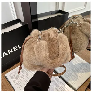 Detail of plush brown bucket bag with soft drawstring and faux leather shoulder strap