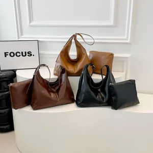 Minimalist leather hobo shoulder bag set with matching clutch available in three colors