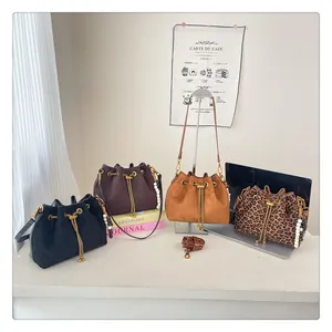Detail view of four drawstring bucket bags in black, brown, camel and leopard print styles