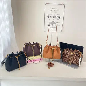 Minimalist suede drawstring bucket bags in various colors with stylish chain straps