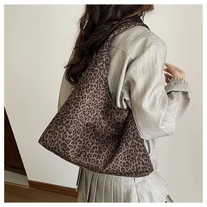 Detail shot of leopard print hobo tote bag in suede material with spacious design