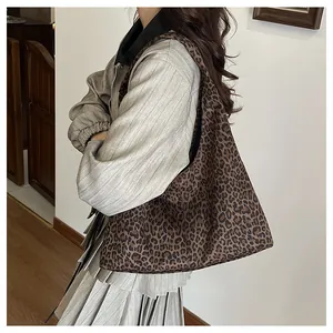 On-body view of large leopard print tote bag showing casual style and hobo shape