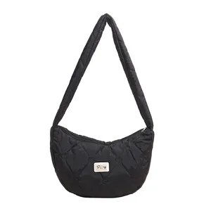 Minimalist black heart-quilted dumpling bag with adjustable wide shoulder strap