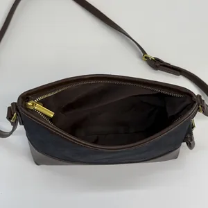 Retro canvas and brown leather bucket bag with top zipper and spacious interior