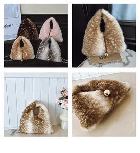 Macro detail of plush triangular faux fur bag with golden ball charm and metallic chain