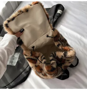 Detail showing plush leopard print texture and drawstring closure of the student backpack