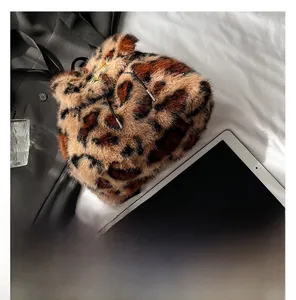 Detail showing plush leopard print faux fur texture and black drawstring closure on backpack