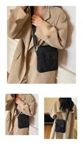 Detailed views of a minimalist black canvas crossbody bag with adjustable fabric strap