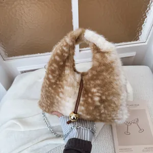 Brown spotted plush handbag with a golden ball clasp and silver chain shoulder strap