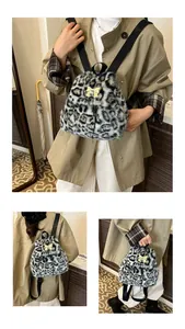 Detail view of mini leopard print faux fur backpack with golden bow and black straps