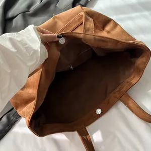 Brown suede tote bag with large capacity featuring magnetic closure and inner pocket