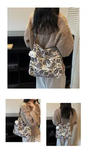 Detail of large paisley canvas tote bag with floral patterns and plush cloud accessory