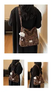 Macro detail of brown paisley hobo bag with a soft cloud charm and brand label