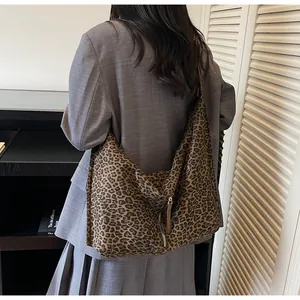Close-up of leopard print tote bag with metal zipper and spacious interior detail