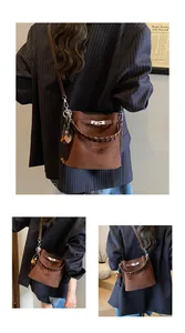 Close-up of vintage brown suede bucket bag with woven handle and silver metal lock