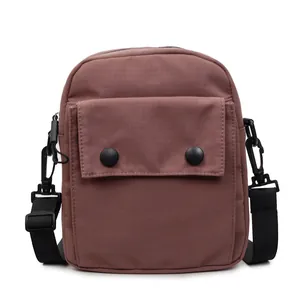 Minimalist mauve canvas crossbody bag with adjustable strap and front buckle pocket