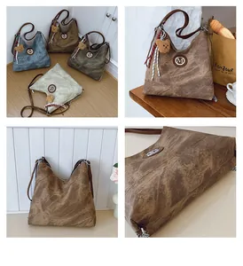 Détail du grand sac à bandoulière en denim avec texture rétro et pendentif ours