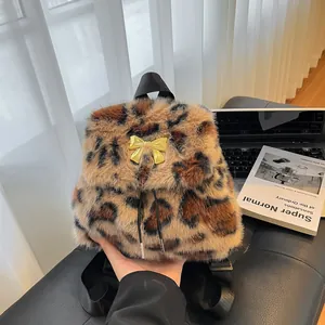 Stylish leopard print faux fur backpack with gold bow and drawstring for autumn fashion