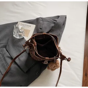 Top view of leopard print bucket bag interior with drawstring closure and brown trim