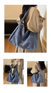 Detail shots of large blue denim tote bag with soft texture and black label detail