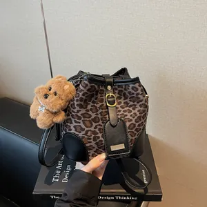 Women Retro Leopard Print Bucket Bag Suede Leather Trim Drawstring Crossbody Bag With Plush Bear Pendant Fashion Handbag