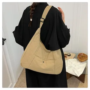 Detail of khaki tote bag with front snap pocket and adjustable wide strap