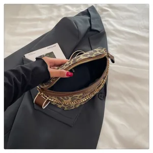 Detail view of leopard print crossbody bag with gold chain and interior brand logo