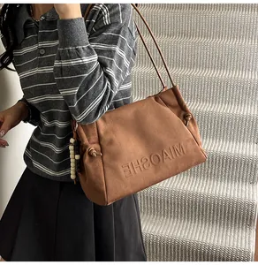 Brown leopard suede tote bag featuring embossed logo detail and beaded charms accessory