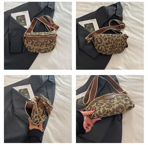 Detail view of leopard print canvas chest bag with gold chain and wide woven strap