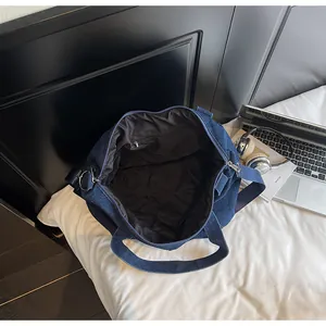 Top view of large denim tote bag interior with zipper pocket and lifestyle accessories