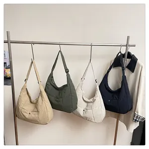 Detail view of multi-color padded tote bags with adjustable wide straps and metal buttons
