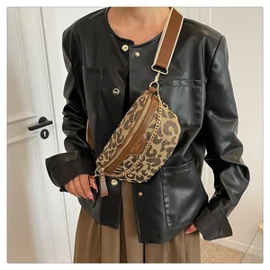 Detail of trendy leopard print crossbody chest bag with wide strap and gold chain