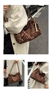 Detailed view of large leopard print tote bag with beaded tassel and shoulder strap