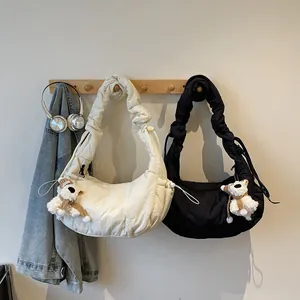 Quilted puffer hobo bag in cream and black with cute plush bear charm decoration