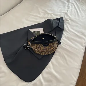 Fashionable leopard print waist bag with gold chain and black adjustable wide strap