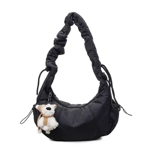 Minimalist black quilted cloud bag with pleated shoulder strap and cute bear pendant