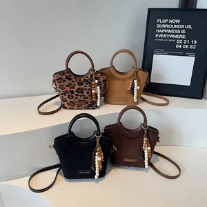 Fashionable suede bucket bags with leopard print and solid colors for shoulder or crossbody