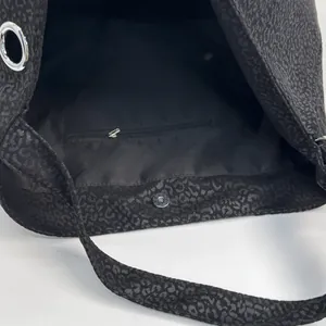 Large leopard print tote bag featuring black suede texture with silver magnetic closure