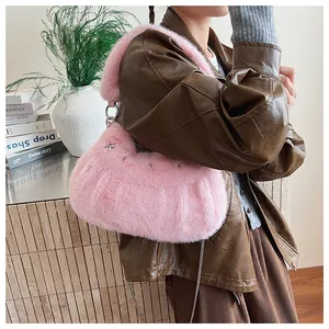 Detail of pink faux fur shoulder bag with star metal studs and delicate chain strap