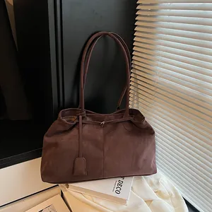 Minimalist large dark brown suede tote bag with slim shoulder straps and fine stitching