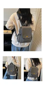 Detail view of grey canvas mini backpack featuring yellow button and side drawstring pockets