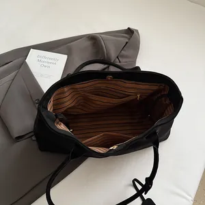 Large black matte tote bag with striped lining and magnetic closure for women